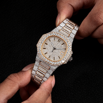 white and yellow iced out watch held in hand with round dial and full diamond shine