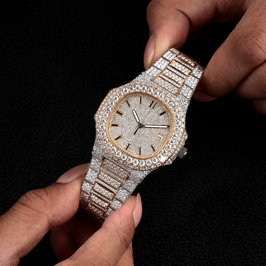 white and yellow iced out watch held in hand with round dial and full diamond shine