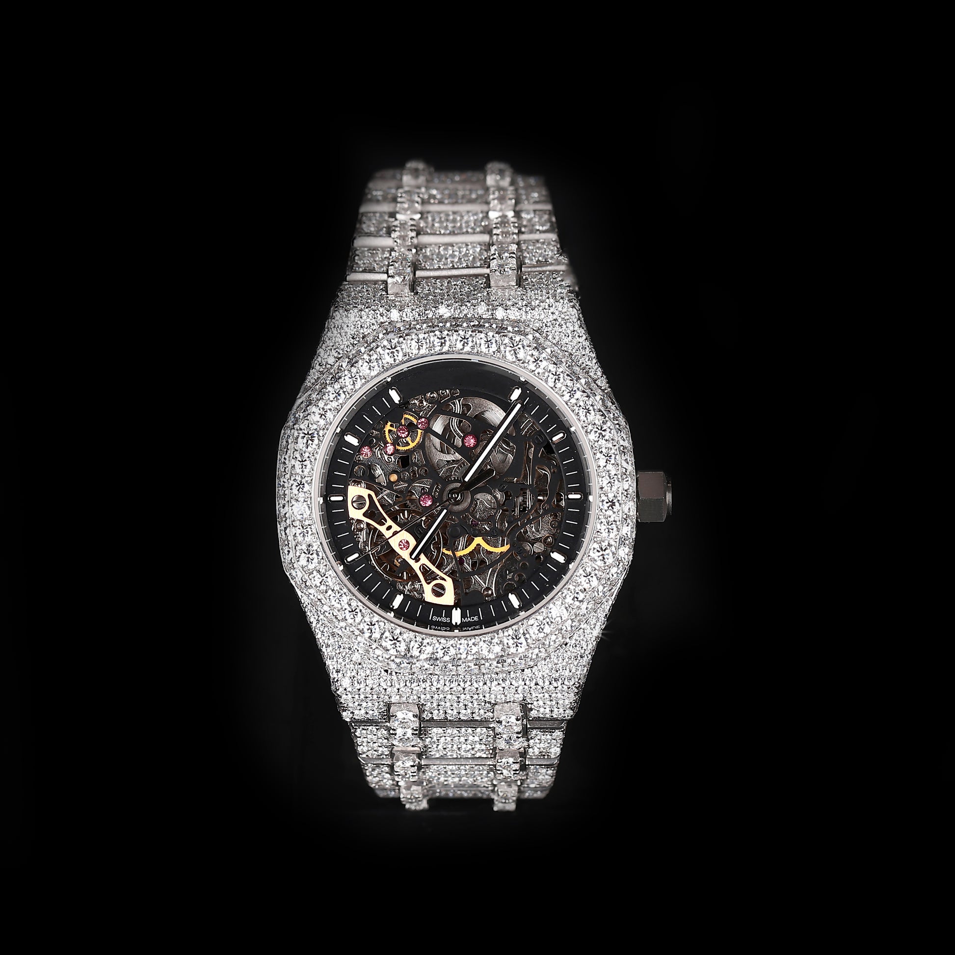 iced out round skeleton watch with black dial and visible mechanical movement