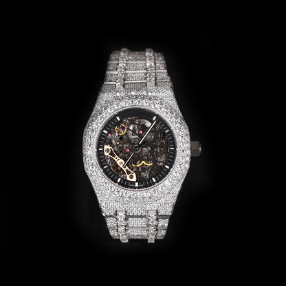 iced out round skeleton watch with black dial and visible mechanical movement