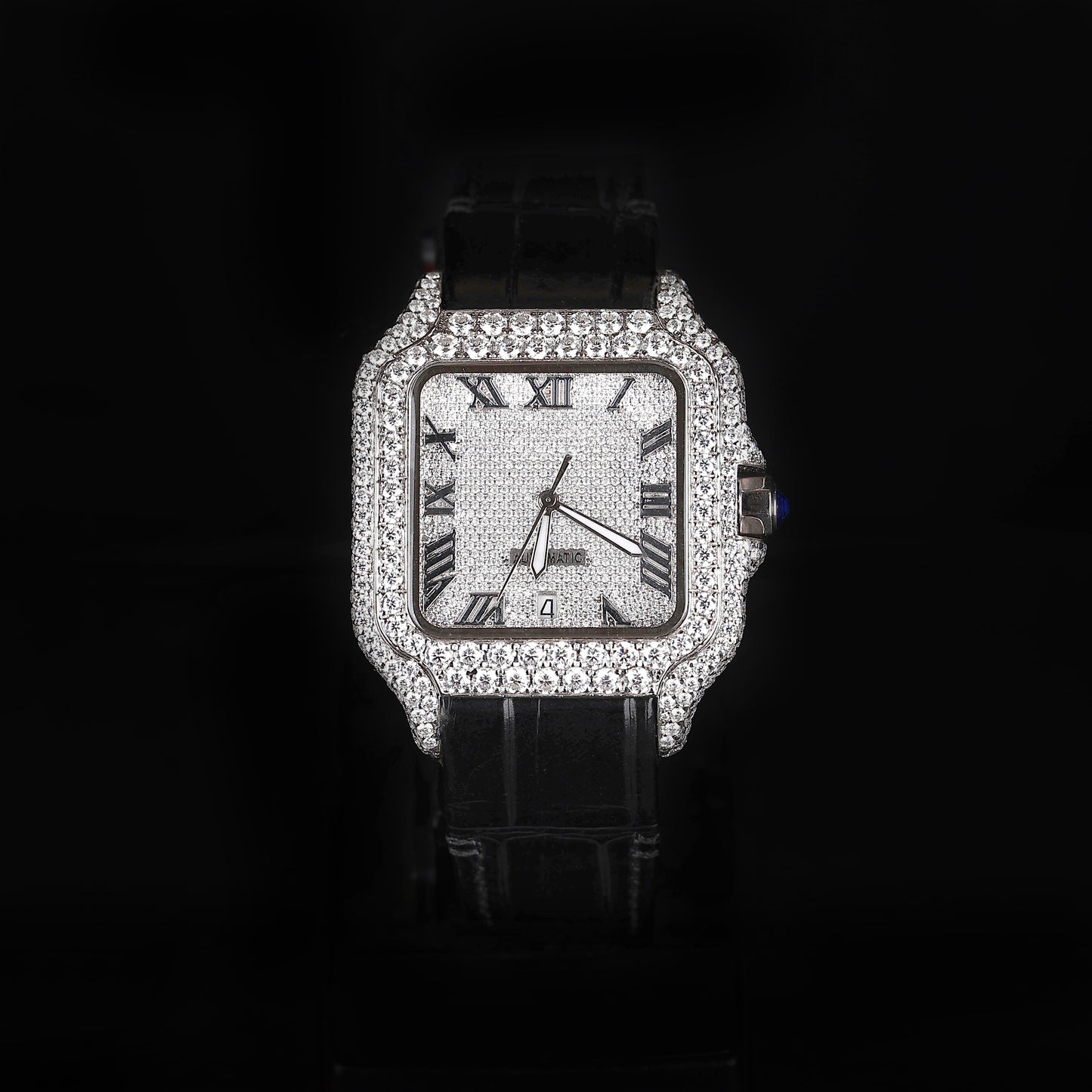 iced out square watch with black leather strap and roman numeral dial