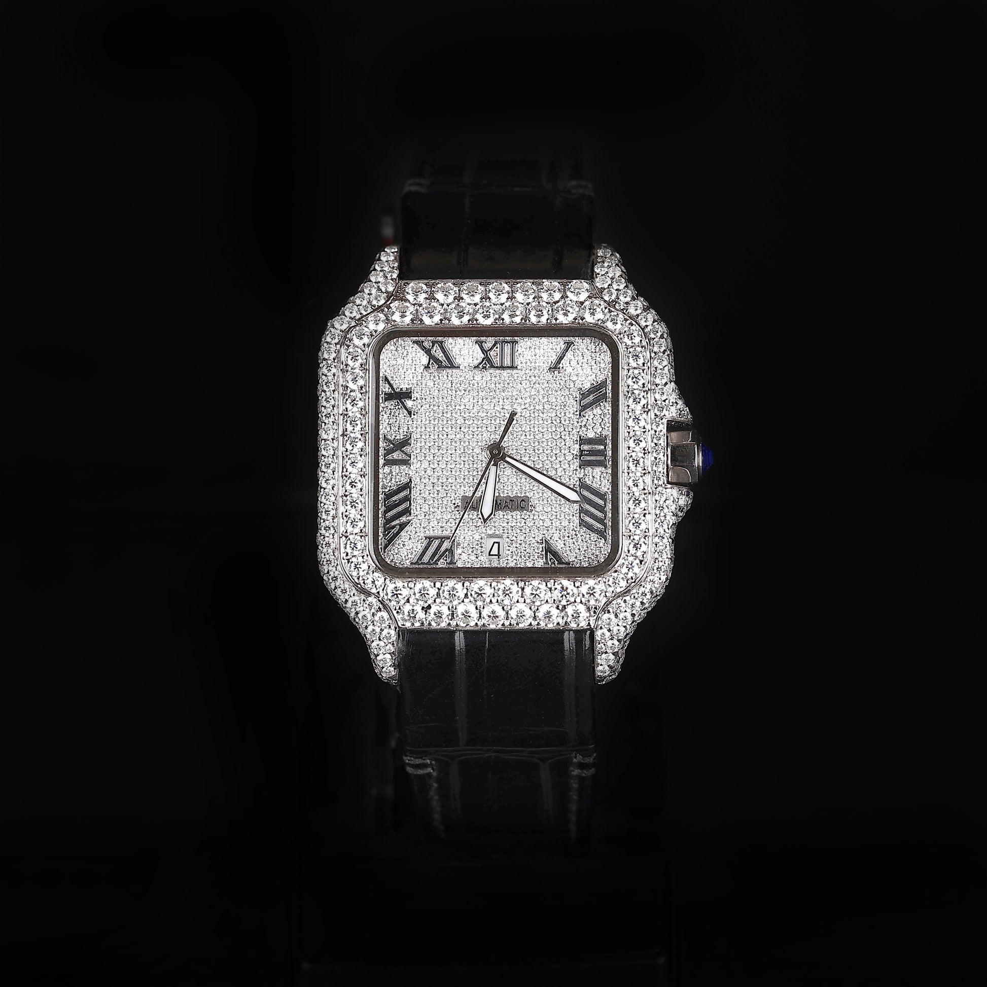 iced out square watch with black leather strap and roman numeral dial