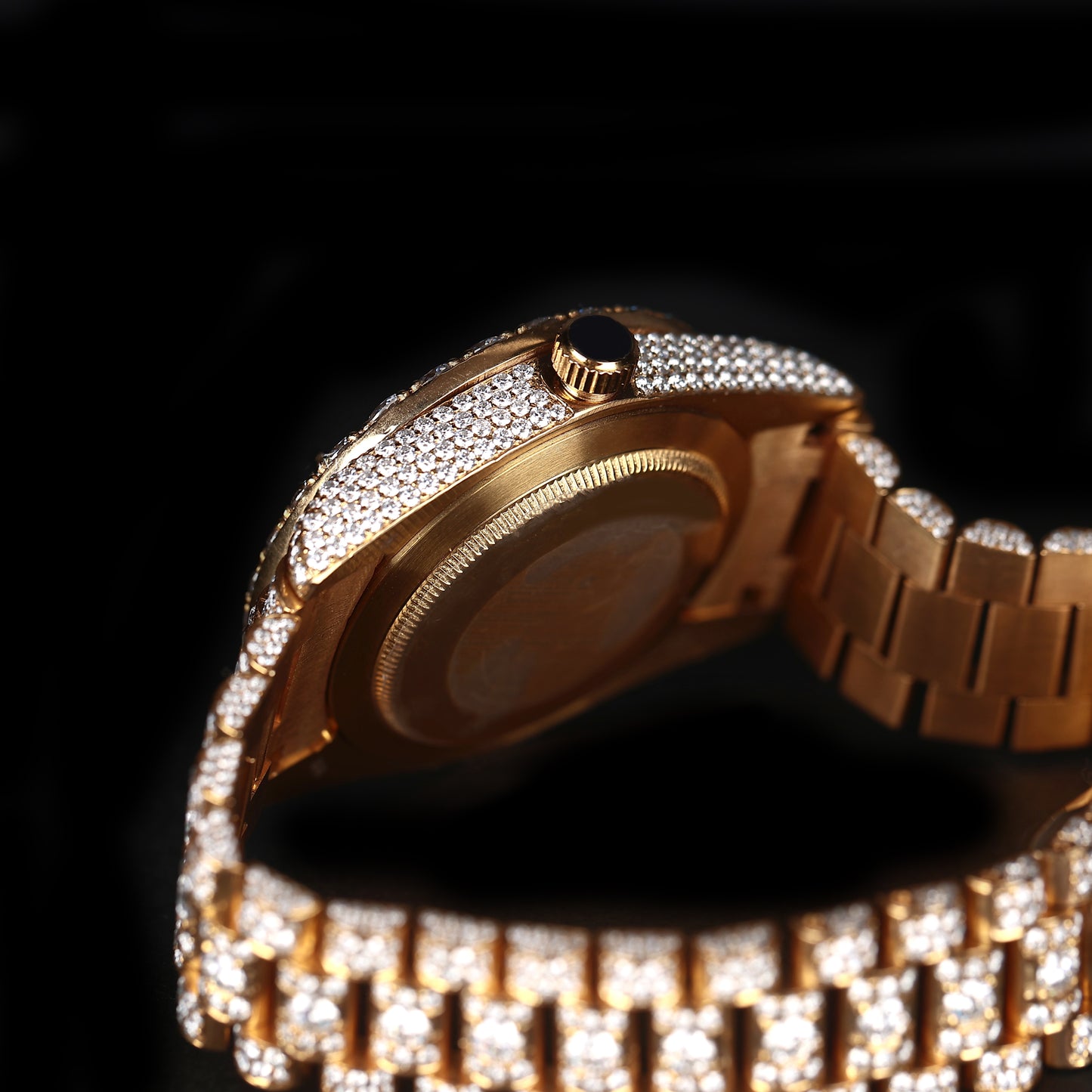automatic luxury watch with gold dial and full stone setting close up