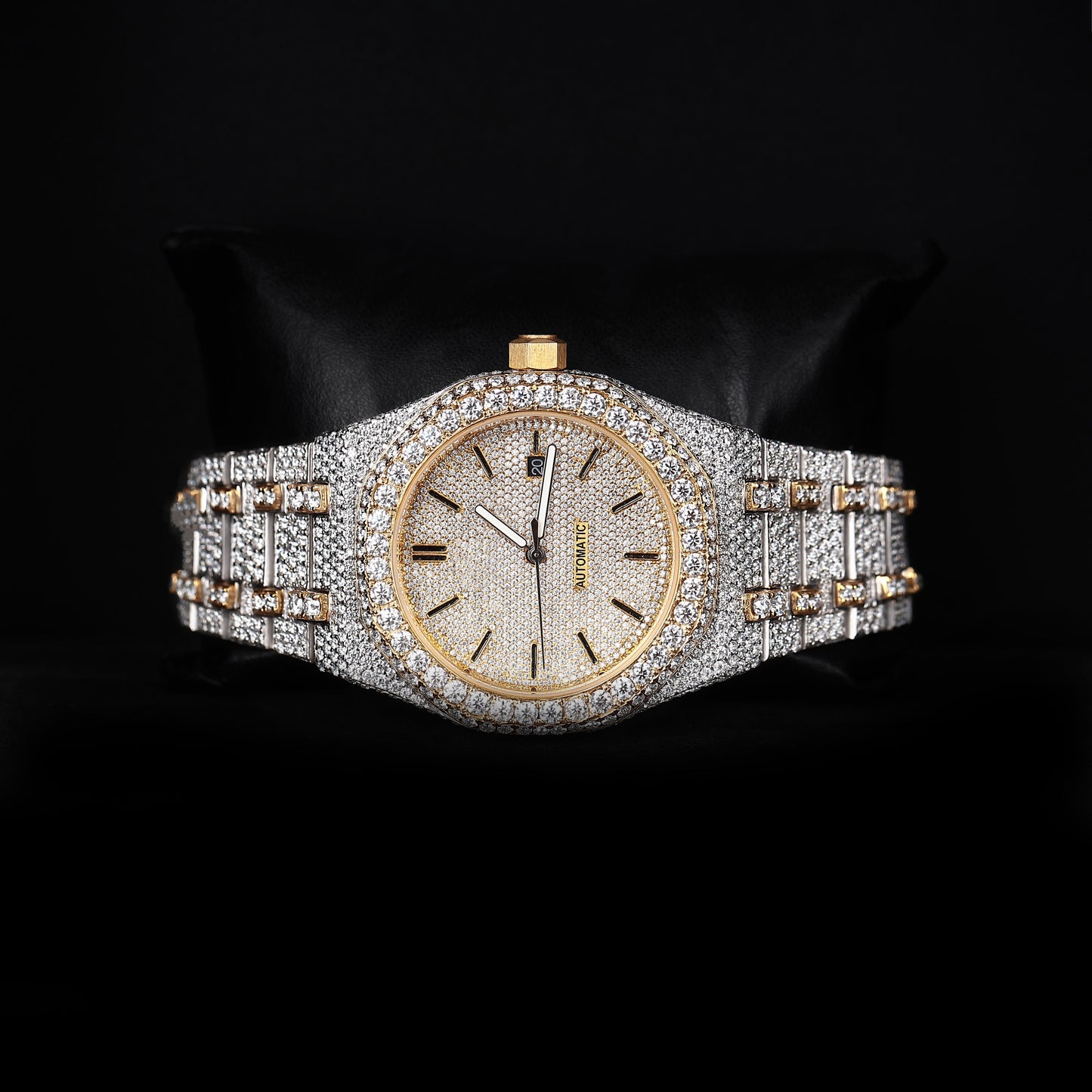 automatic luxury watch with iced bezel and detailed bracelet close up