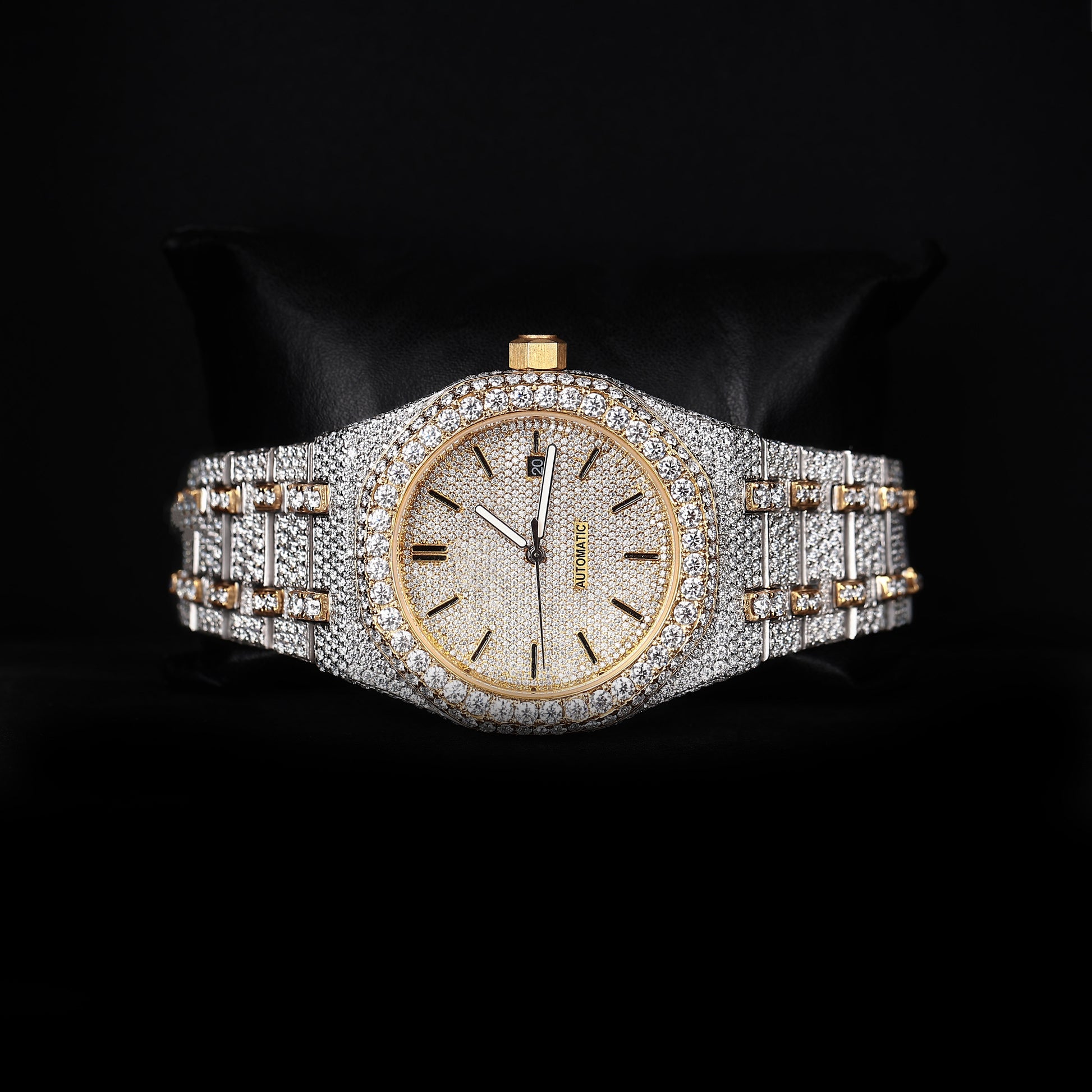 automatic luxury watch with iced bezel and detailed bracelet close up