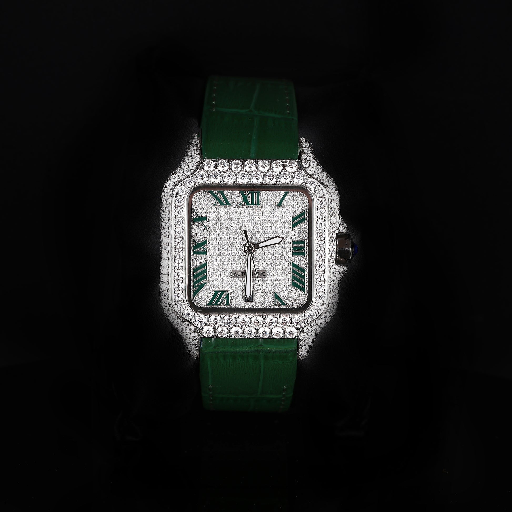 iced out square watch with green leather strap and roman numeral dial
